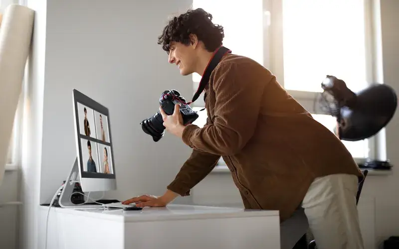Man looking at the photos he clicked on his computer