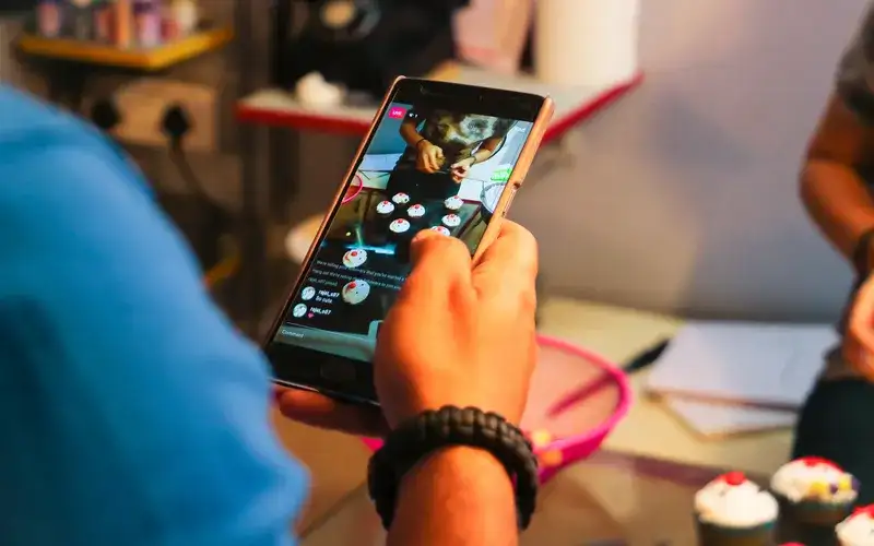 person on phone scrolling through social media