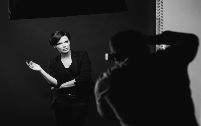 Photographer directing a subject during a black and white figure photography session