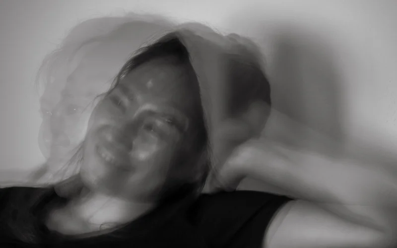 Monochrome portrait of a thoughtful woman in motion.