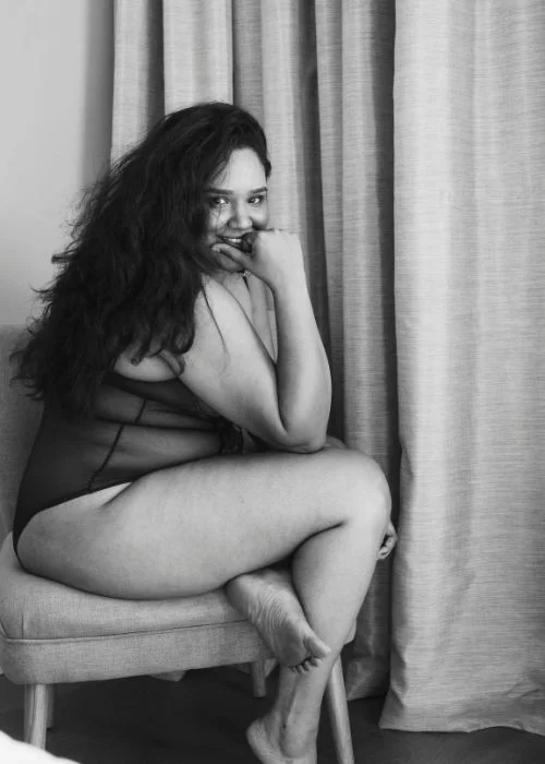 Artistic curvy boudoir photography with flattering angles and cinematic mood