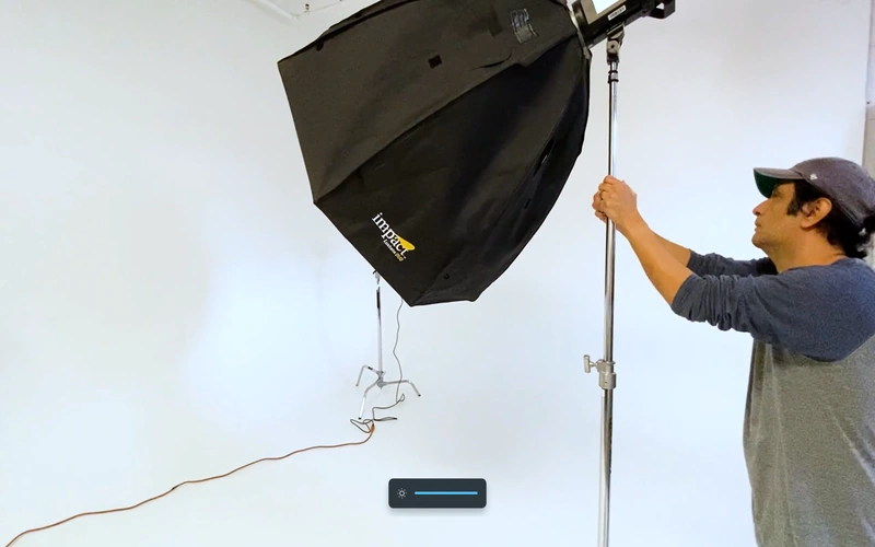 Photographer adjusting the lighting equipment in his studio