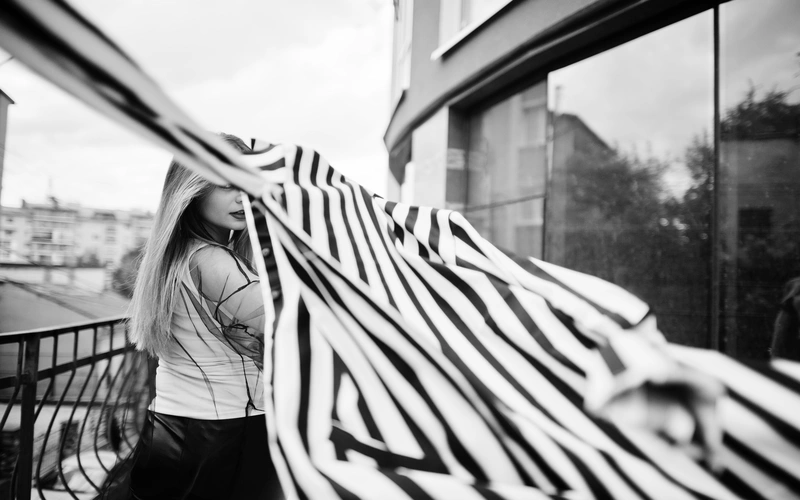 High-contrast zebra lighting casting shadows in abstract body photography