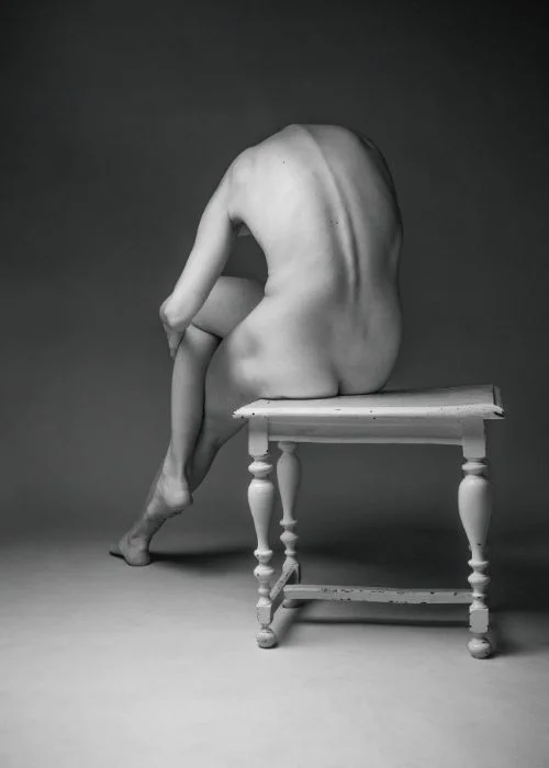 Elegant fine art nude photography showcasing timeless composition and soft shadows