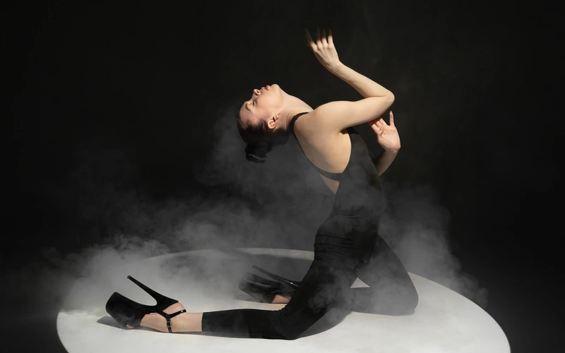Model twisting into a dynamic pose for abstract figure photography.