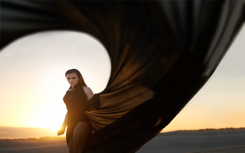 Model posing for striking abstract figure photography in a studio setting.
