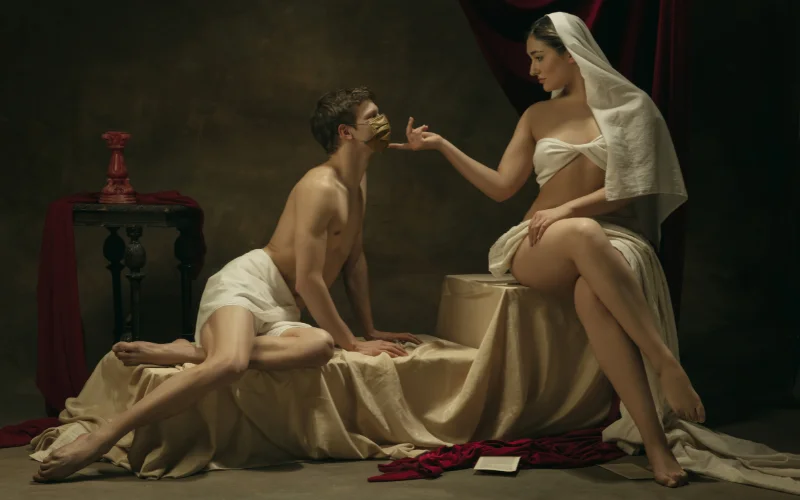 two naked couples on a beach getting married