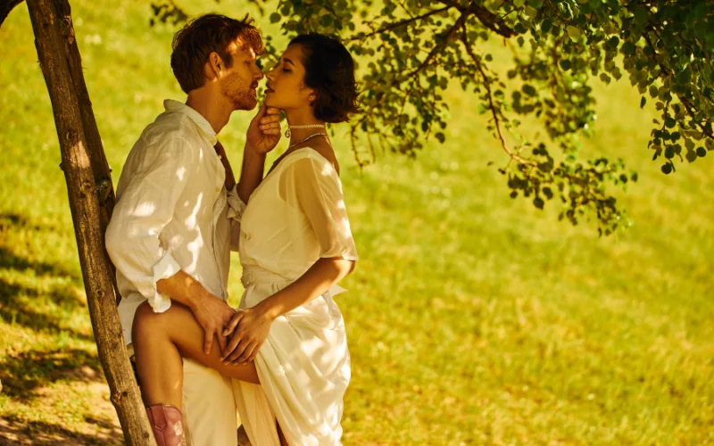 black and white image of a naked couple on a beach