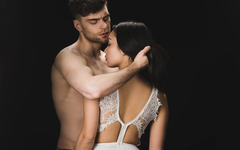 couple embracing each other in studio and posing for their boudoir wedding photoshoot