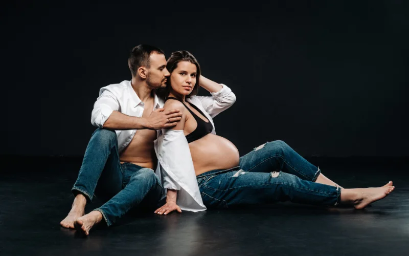 Boudoir maternity photoshoot of expecting couple
