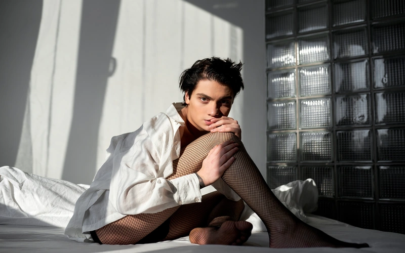 Boudoir pose of a man sitting