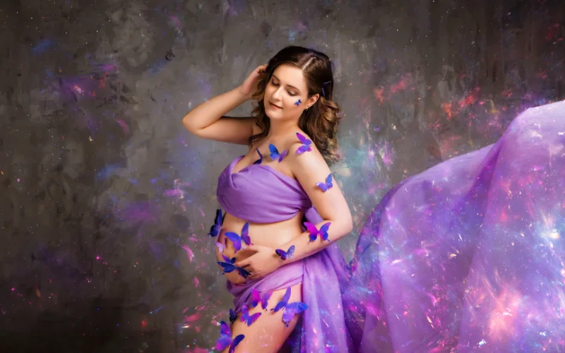 pregnancy boudoir photography of woman wearing glitter and stickers