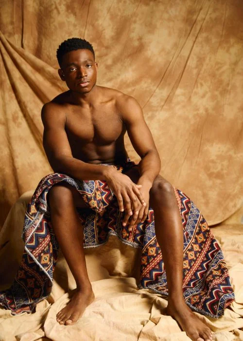Male nude model reclining naturally for elegant fine art portrait photography