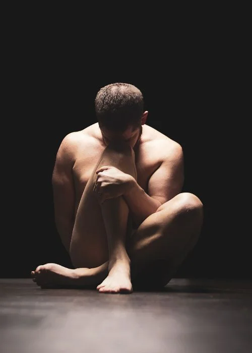 Fine art male nude portrait with cinematic lighting and artistic body positioning