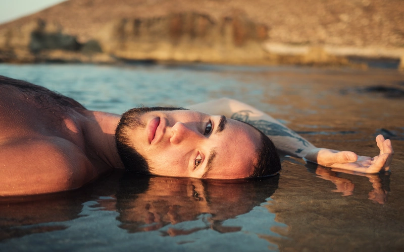Boudoir photoshoot of a man lying down