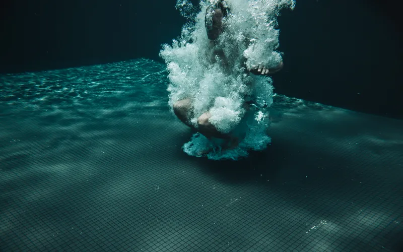 Model splashing playfully during a lively underwater photoshoot