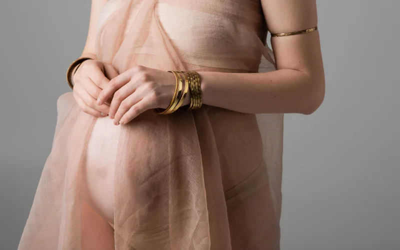 Boudoir maternity photo shoot of a model wearing jewellery
