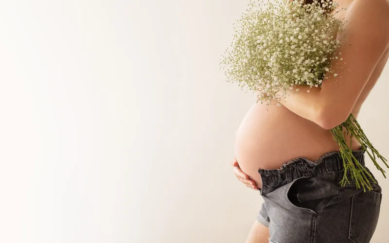 pregnant woman covering with flowers