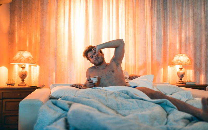 Boudoir portrait photography of a man in sheets