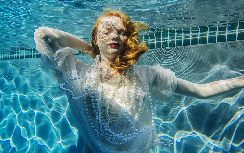 Model against sunlight for a dramatic underwater boudoir photography shot