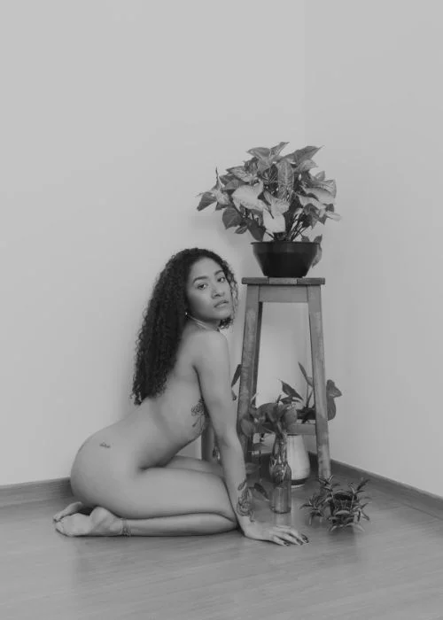 woman sitting near plants