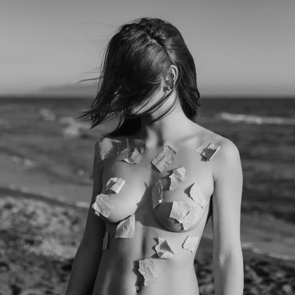 nude woman covered with paper