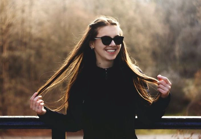 beautiful woman holding locks of her hair
