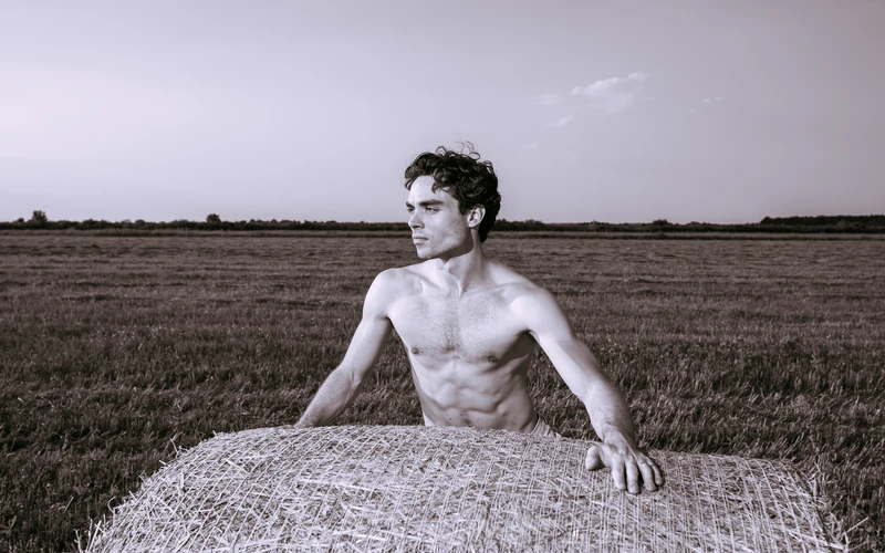 Male model posing outdoors for natural figure photography poses.