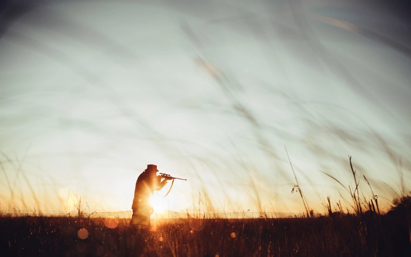 Model posing in an open landscape for striking photography in nature.