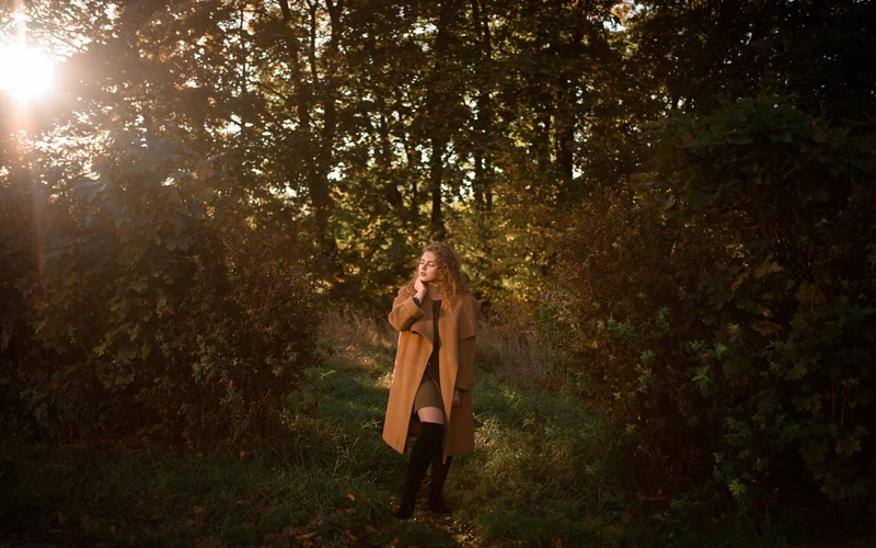 Model posing in dramatic shadow for moody human figure poses.