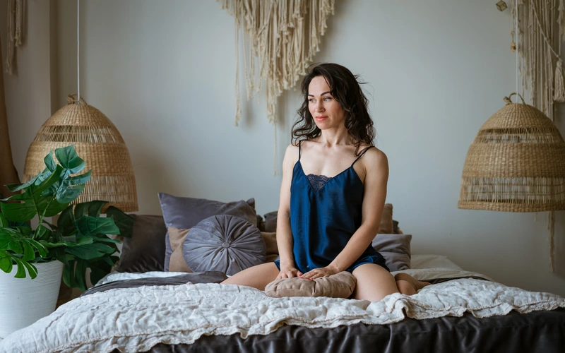 boudoir photography of a woman sitting on the bed