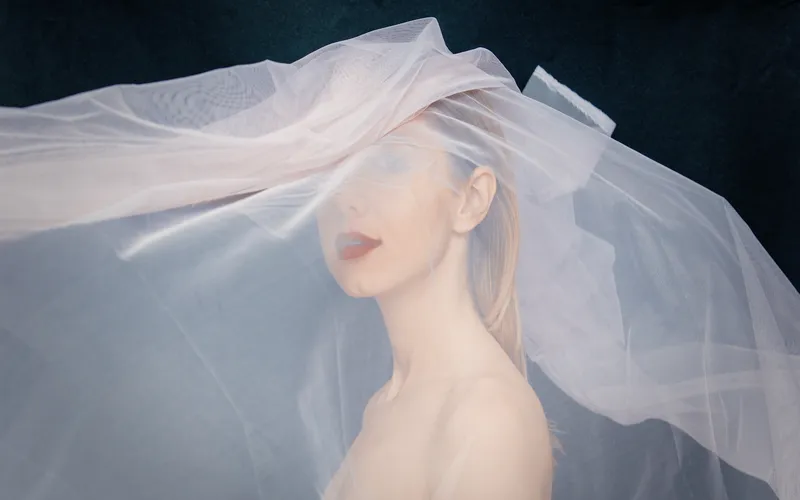 wedding Boudoir photography of a woman posing with veil