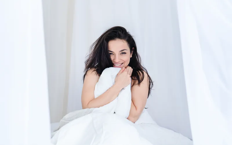 women posing with white bedsheet for her Boudoir wedding photography