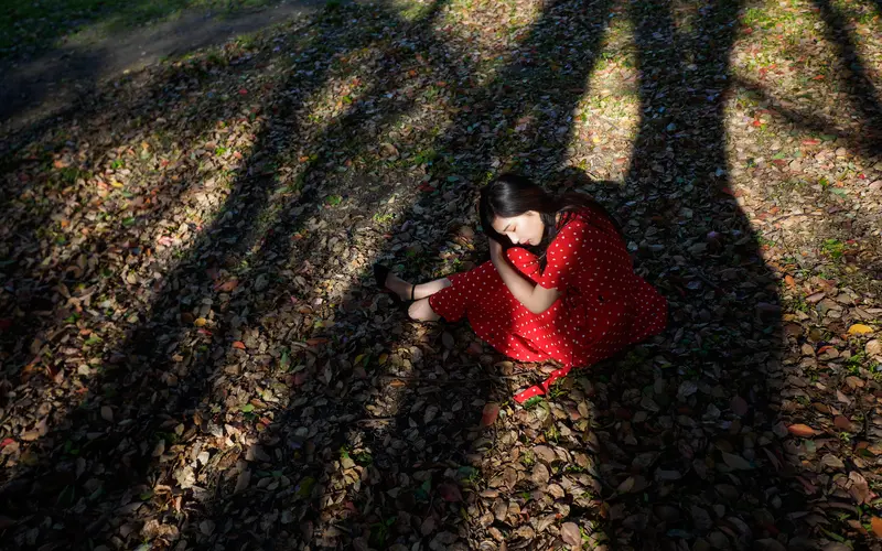 Model positioned in natural light for artistic photography in nature.