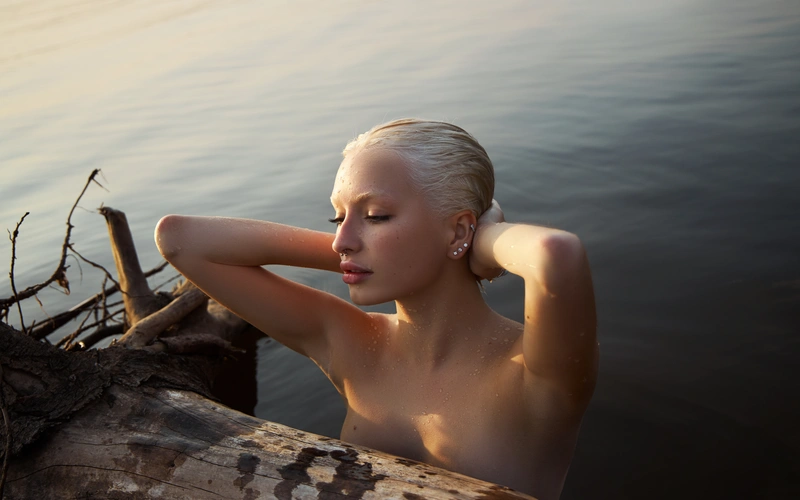 portrait of a Young blonde woman in a lake