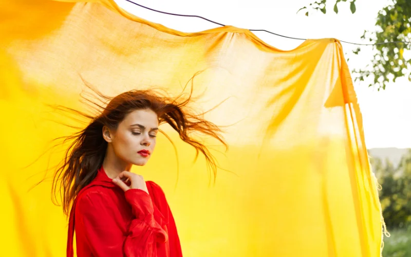 Model's hair cascading over her shoulders in an implied photoshoot pose that uses natural texture to soften the frame