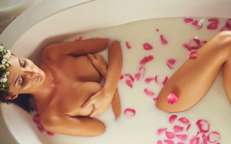 milk bath nude in rose petals, creative milk bath portraits, professional milk bath photography, feminine milk bath photography, aesthetic milk bath photography
