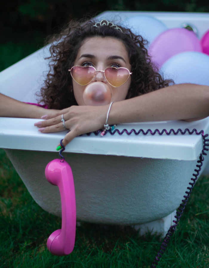 Girl in bathtub with balloons
