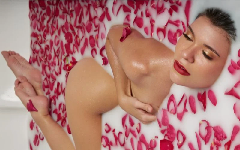 milk bath nude in rose petals, creative milk bath portraits, professional milk bath photography, feminine milk bath photography, aesthetic milk bath photography
