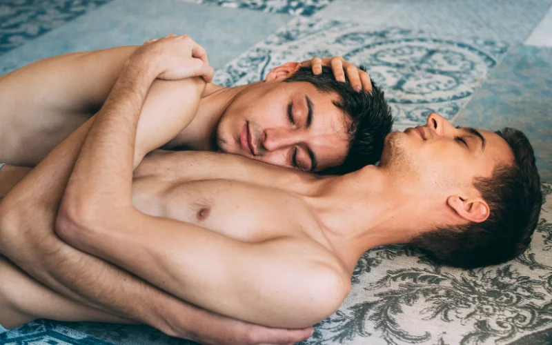 gay nude photoshoot - two men cuddling on the floor