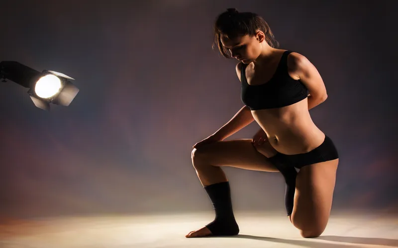 Dramatic side lighting falling across a model's silhouette