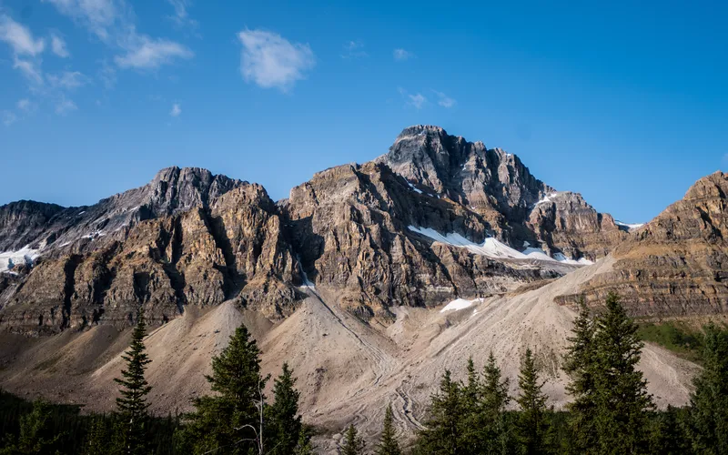 mountain range under a partly cloudy sky