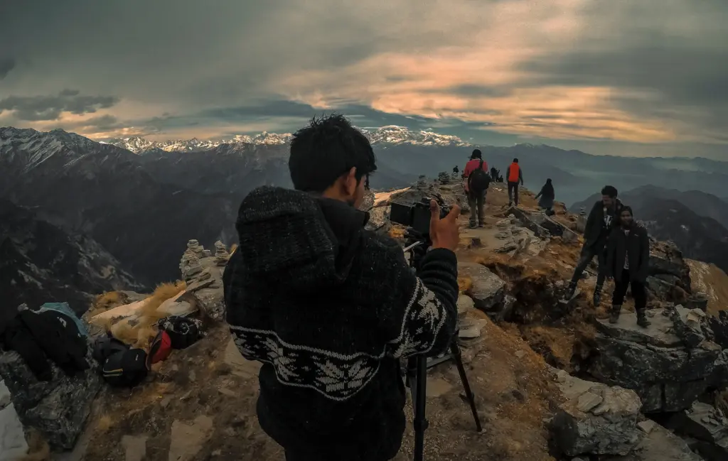 photographer clicking photo on a hill