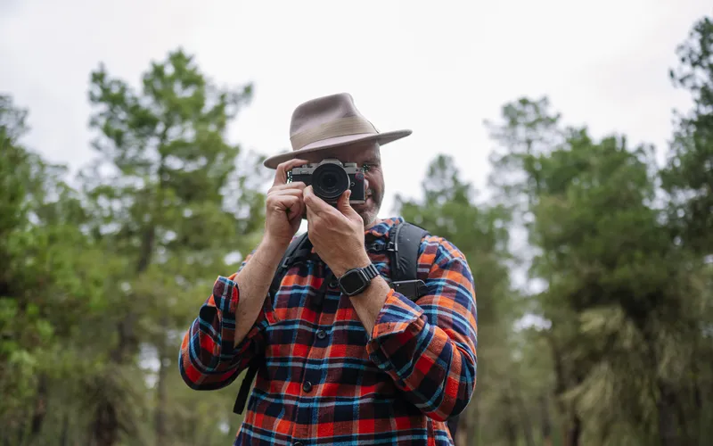 portrait of a man taking a photo with camera