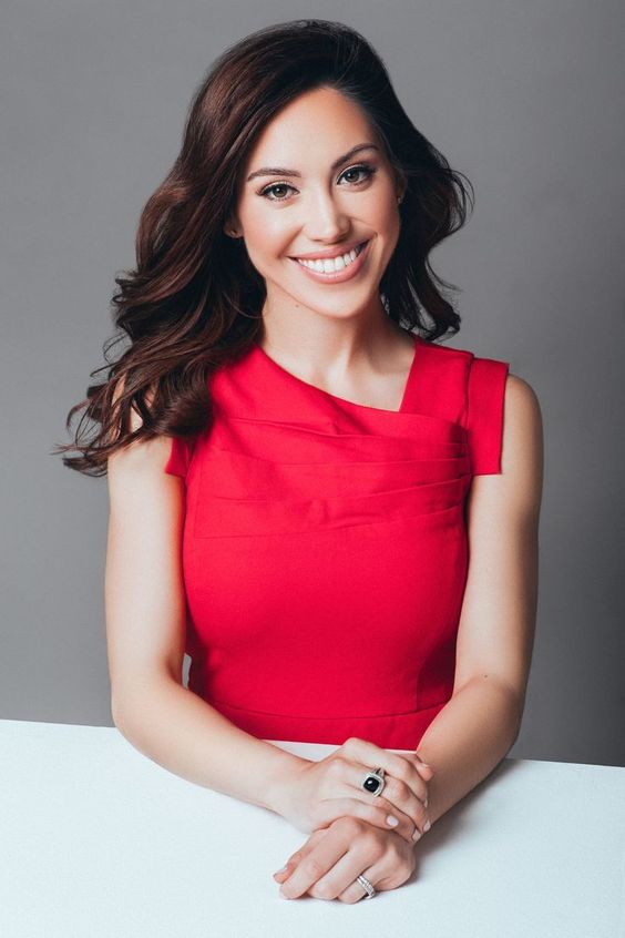 Sitting on the table with hands folded headshot pose