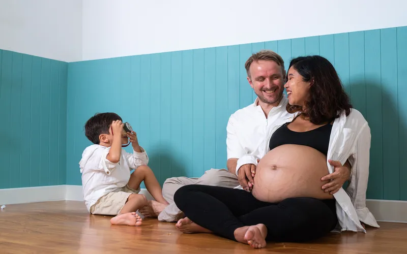 kid taking pictures of expecting mom and dad
