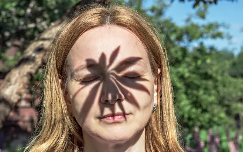 woman's portrait with shadow of leaf on her face