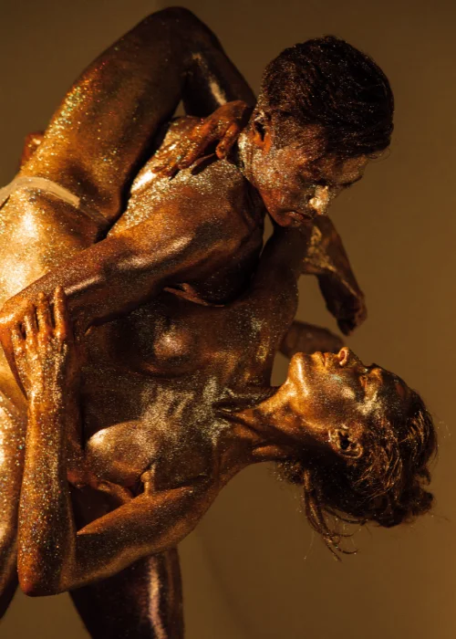 a nude men and women posing drenched in glitter