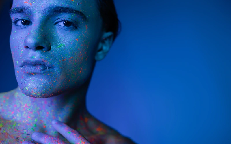 Man posing for his Boudoir photoshoot covered in glitter