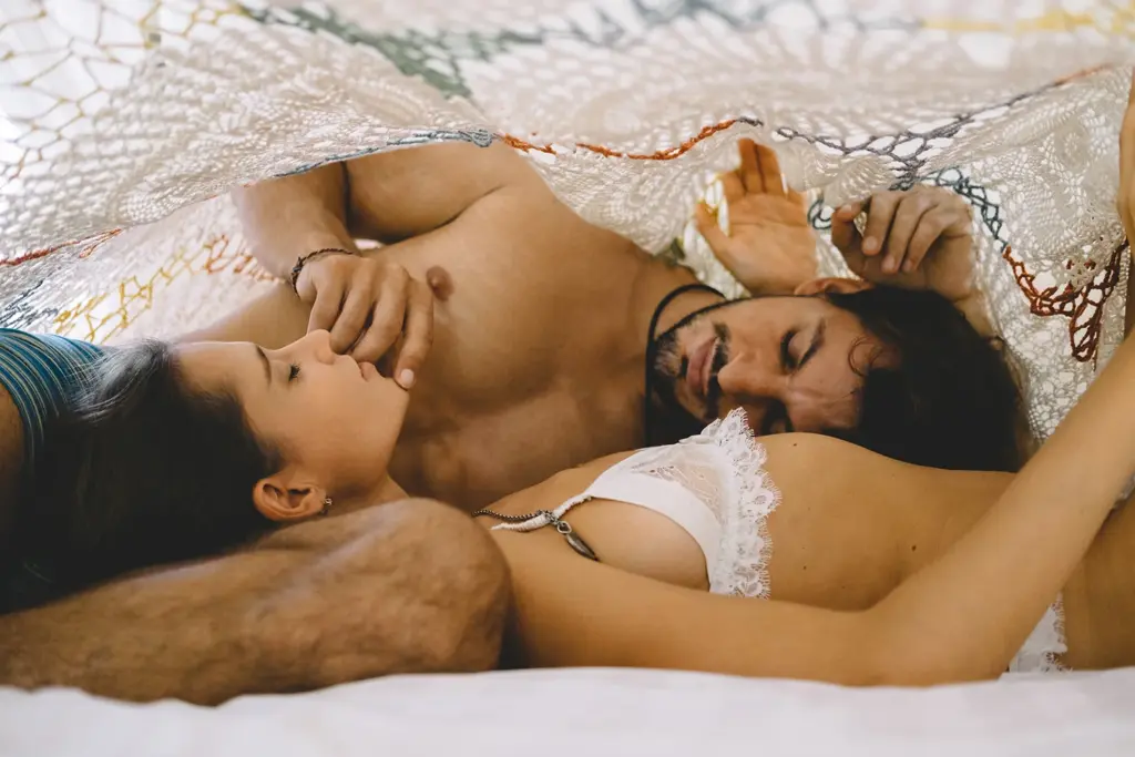 couple posing under the sheet